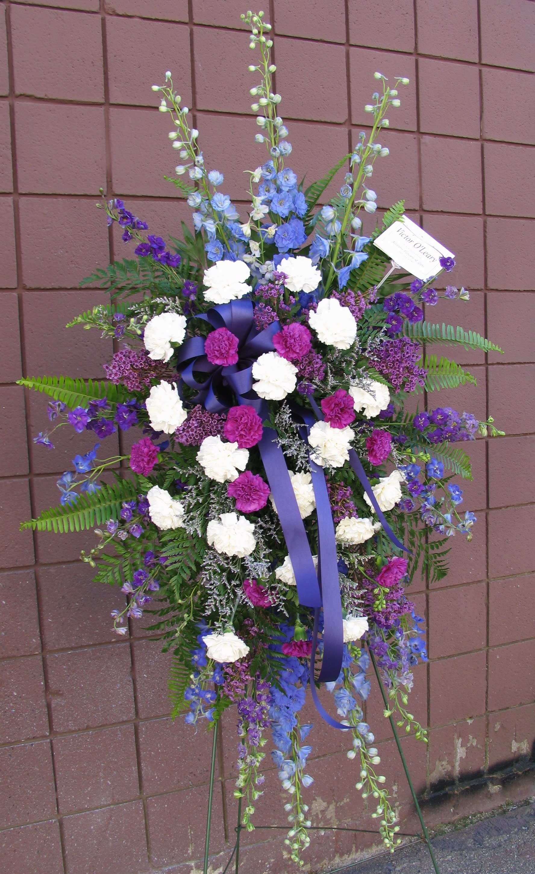 Tall standing floral spray with purple, blue, and white flowers
