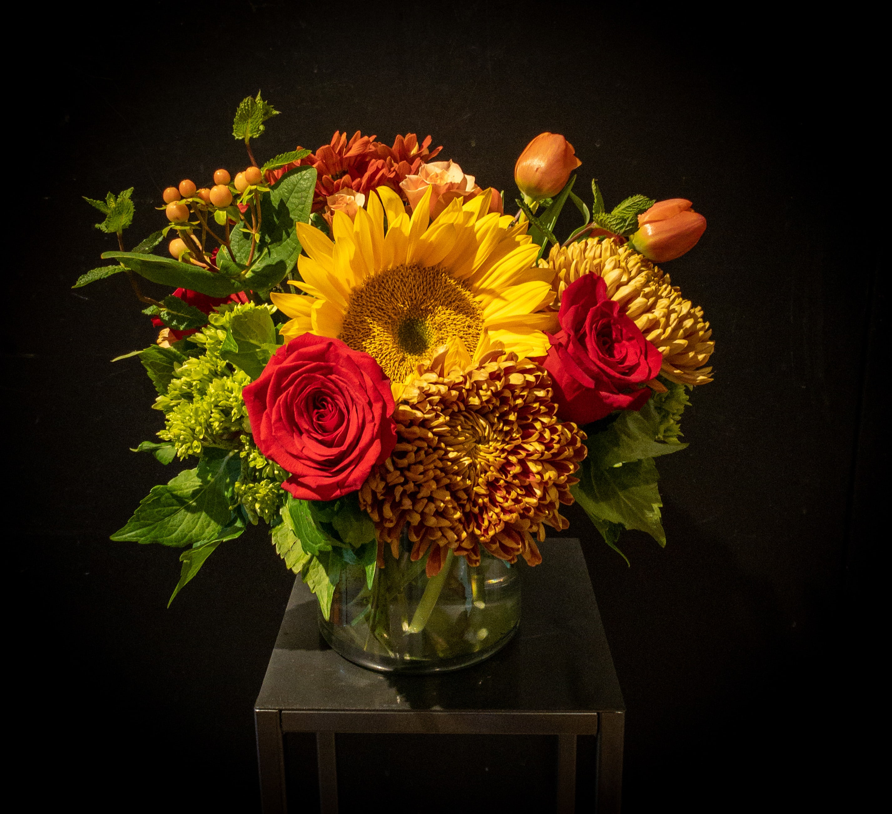 Autumn Splendor - Vibrant collection of beautiful blooms in Autumn hues.. including  roses, berries, bronze Chinese chrysanthemums and more.  Carefully gathered and placed in a vase.  Standard is approx 10x10x10