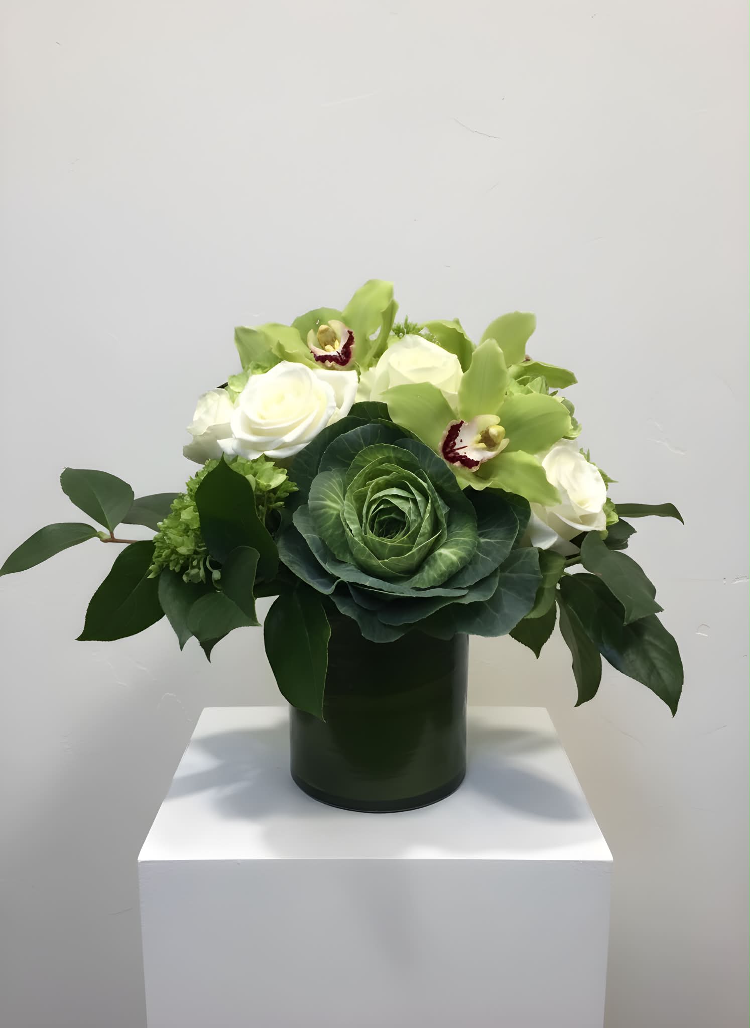 Feelin' Green - A mix of brightly colored greens accompanied by white roses, green hydrangea, and cymbidium orchids. 