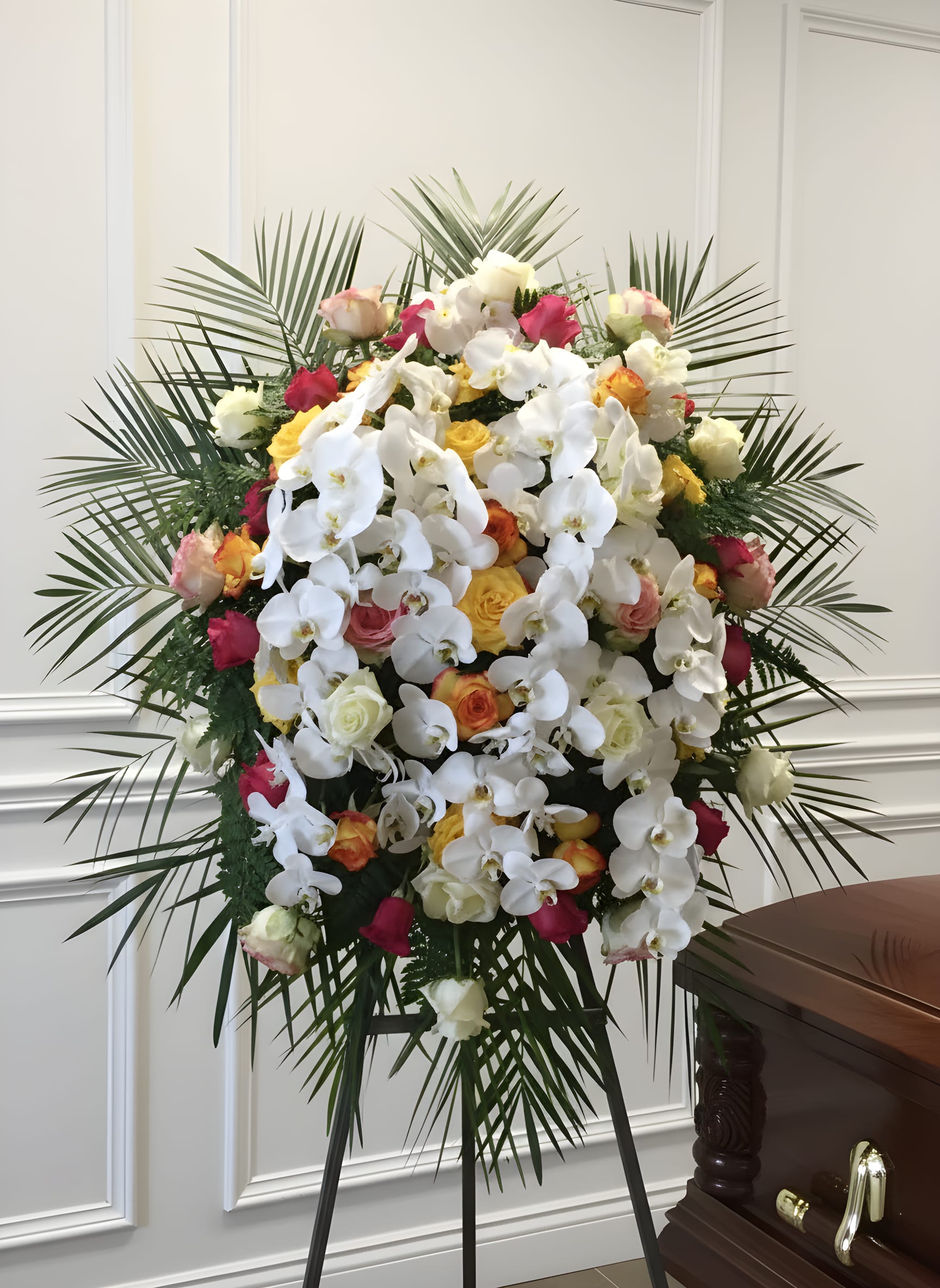 Premium Funeral Spray - An amazing combination of flowers creating a magnificent display. Cascades or orchids are blended with various types of roses and other flowers creating a very unique look. 