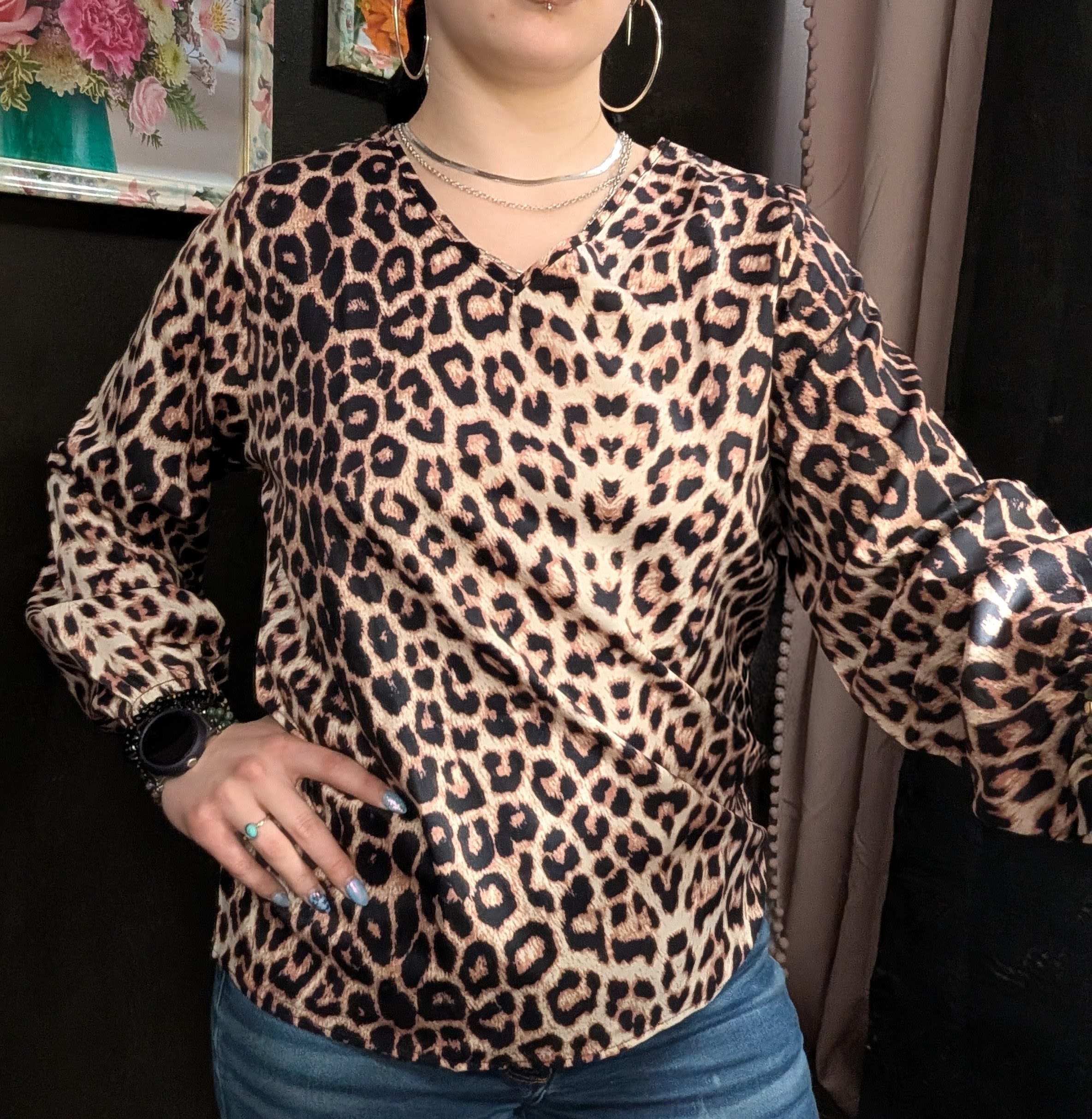Person wearing a leopard-print blouse and jeans