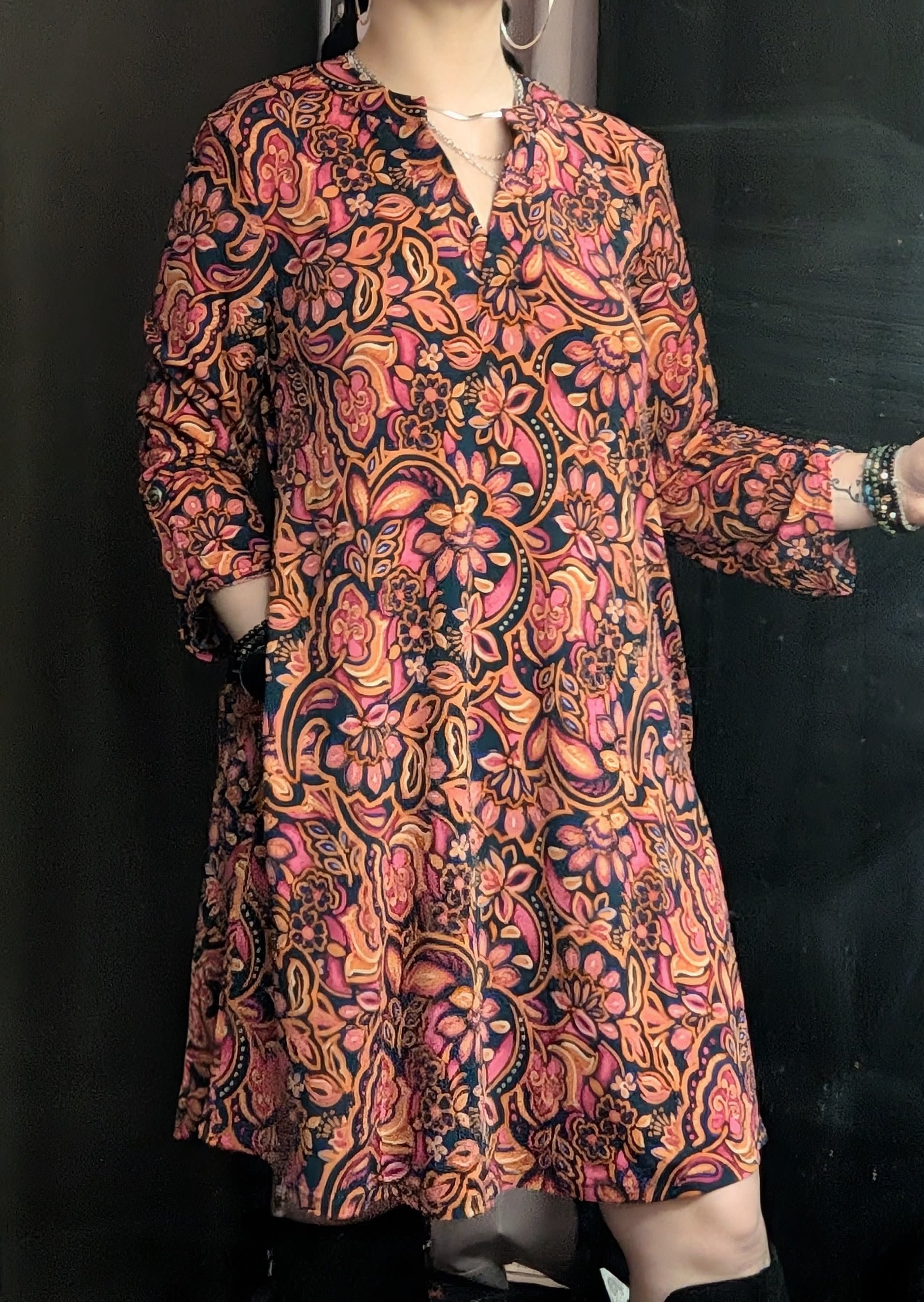 Person wearing a colorful floral-patterned dress