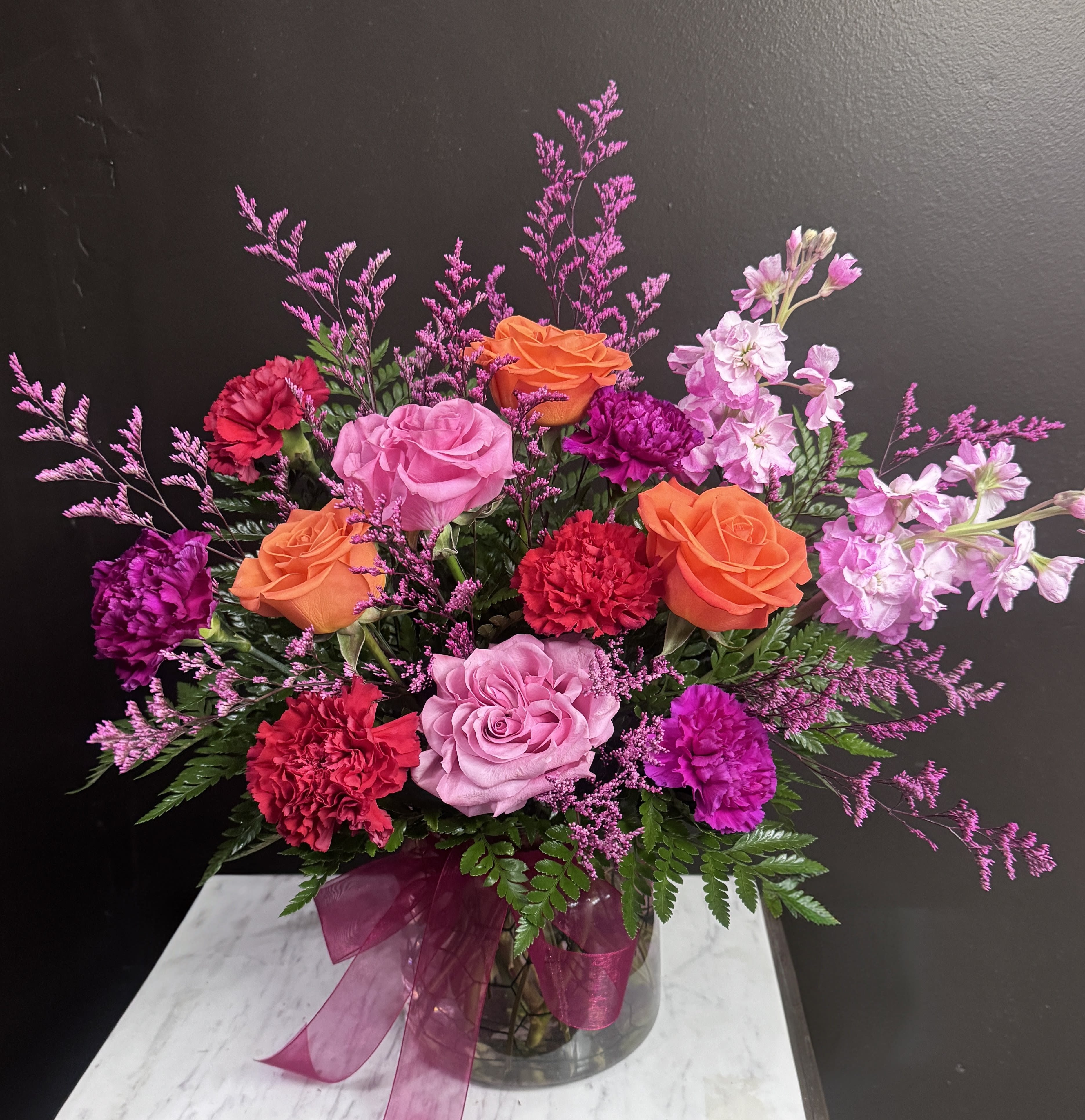 Berry Burst - Rich pinks purples and oranges in a clear glass vase.