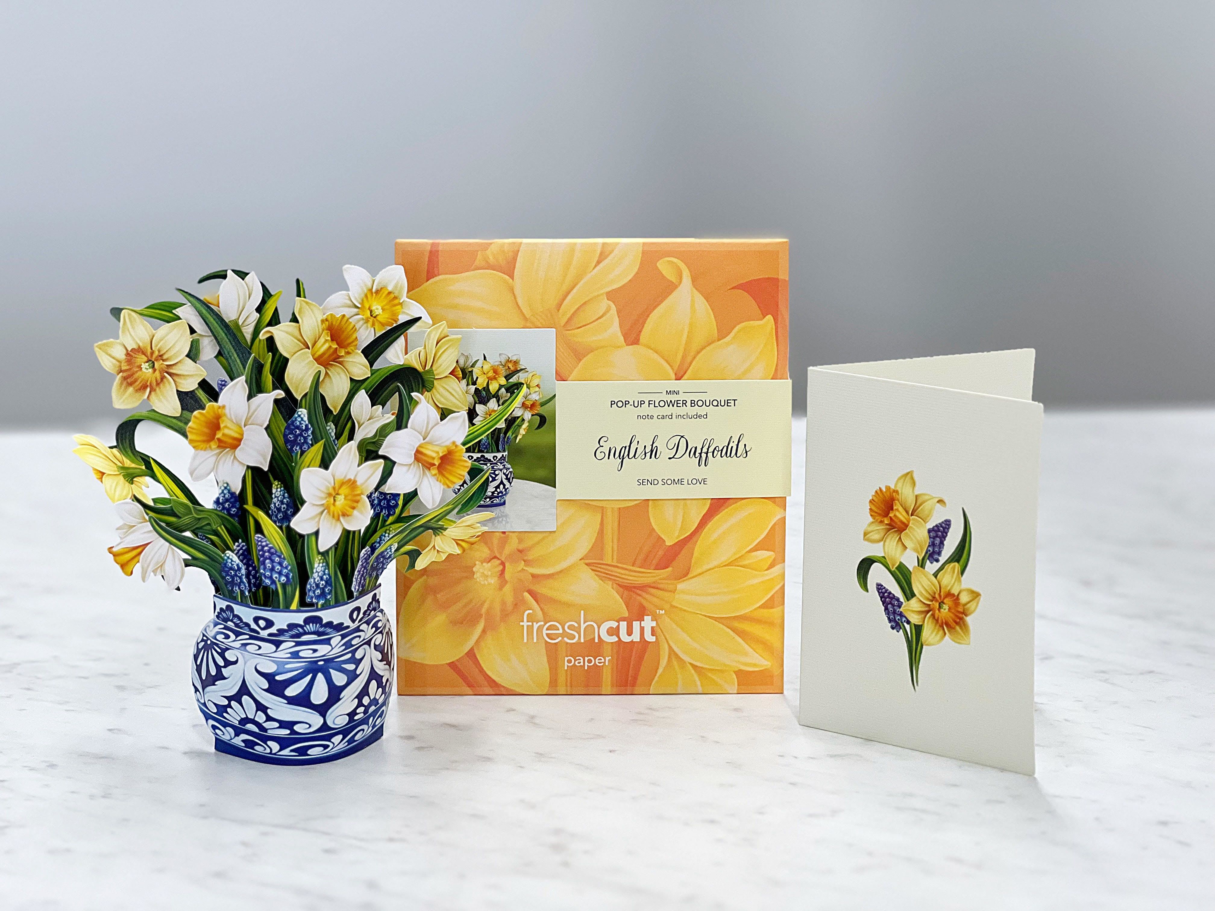 Pop-up bouquet of yellow and white daffodils in a blue patterned pot with a card