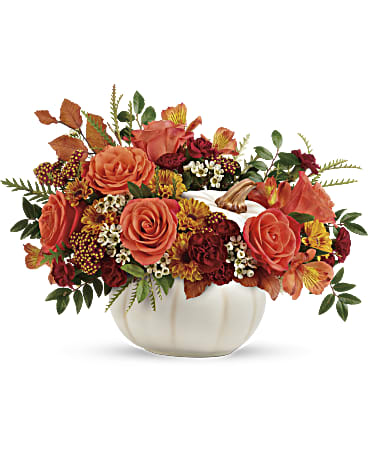 White Pumpkin Harvest - This elegant floral arrangement celebrates the spirit of autumn with a charming white pumpkin-shaped container. A vibrant array of fall-colored flowers, including roses, carnations, and alstroemeria, fills the pumpkin, creating a warm and inviting centerpiece. The inclusion of autumn leaves and other seasonal elements adds a touch of natural beauty. This unique design is perfect for decorating your home during the Thanksgiving season and bringing a touch of autumnal cheer to your space.