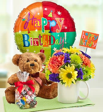 Birthday balloon, teddy bear, candy bag, and flower mug arrangement