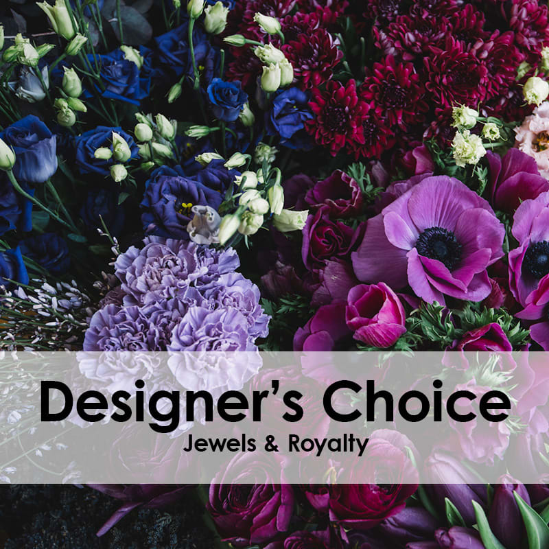 Mixed bouquet of purple, blue, and pink flowers with a text banner