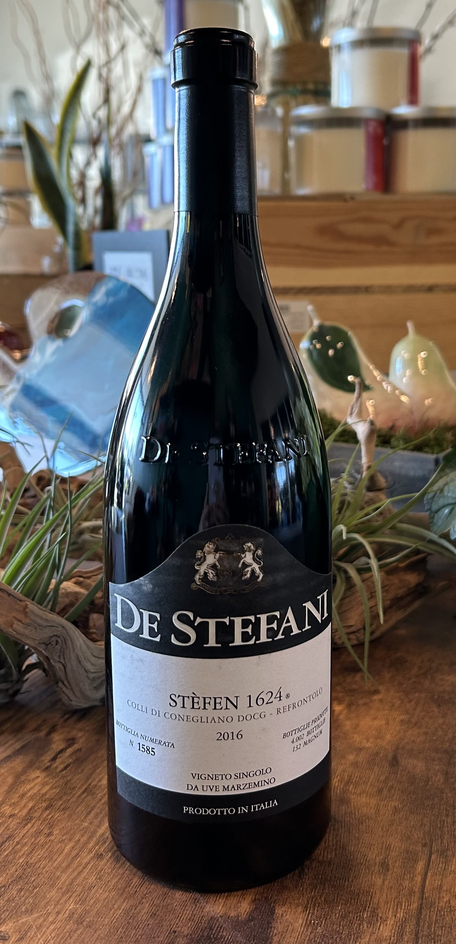 A bottle of De Stefani wine on a wooden surface