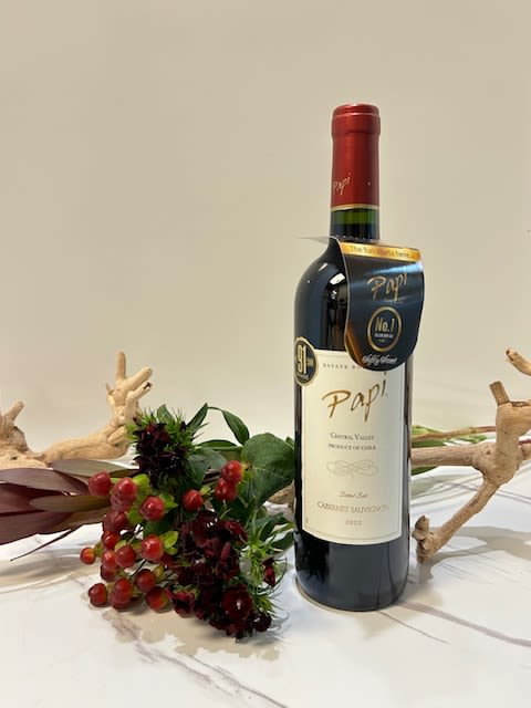 Wine bottle with a small red berry floral accent