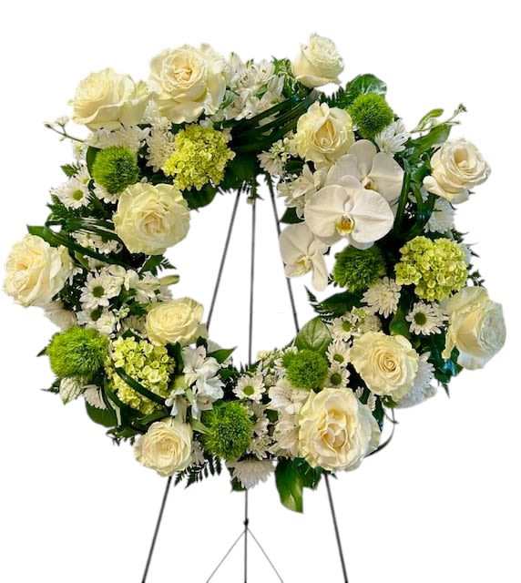 Cream rose and orchid wreath on a standing easel