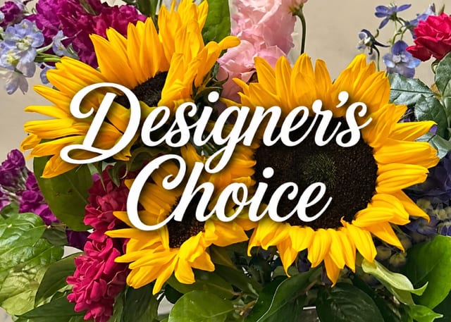 Sunflower Symphony in Vase | Designer’s Choice - A one-of-a-kind floral arrangement created by our expert designers, featuring radiant sunflowers complemented by a curated mix of seasonal blooms and textures. Thoughtfully arranged in a vase, each piece is designed to feel full, balanced, and naturally elegant—an elevated expression for any occasion.