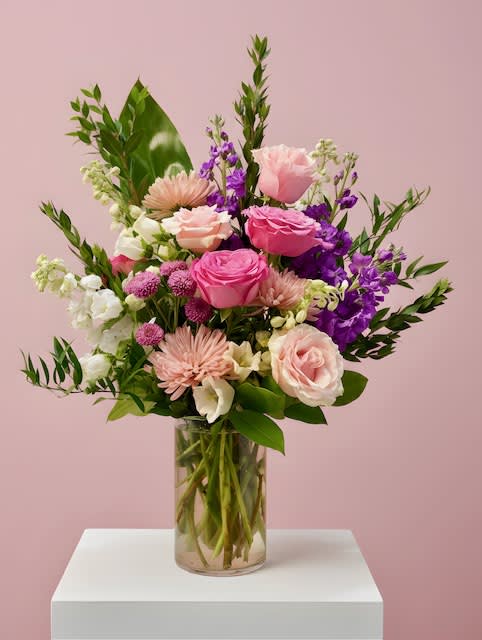 Pink and purple mixed bouquet in a clear glass vase