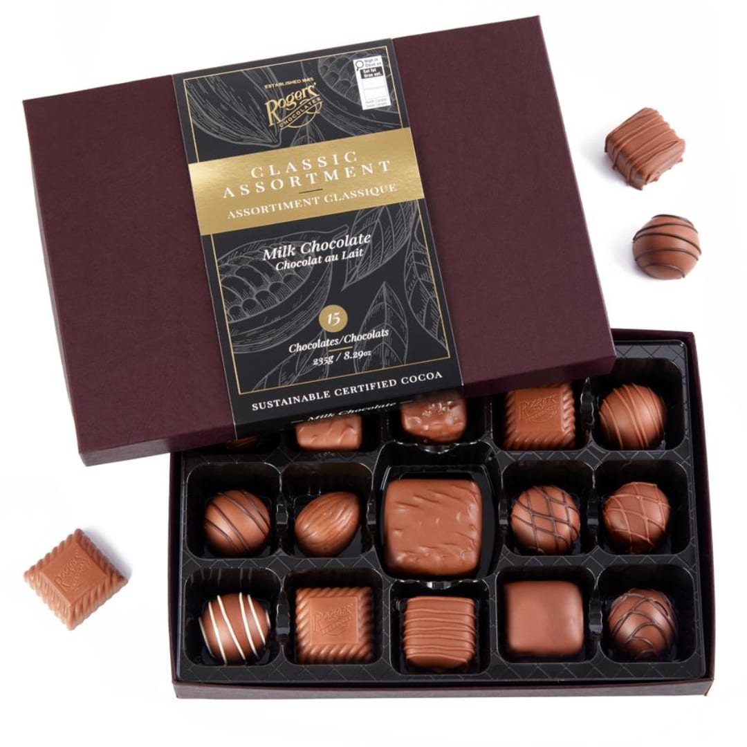 Box of assorted milk chocolates with several pieces outside the open lid