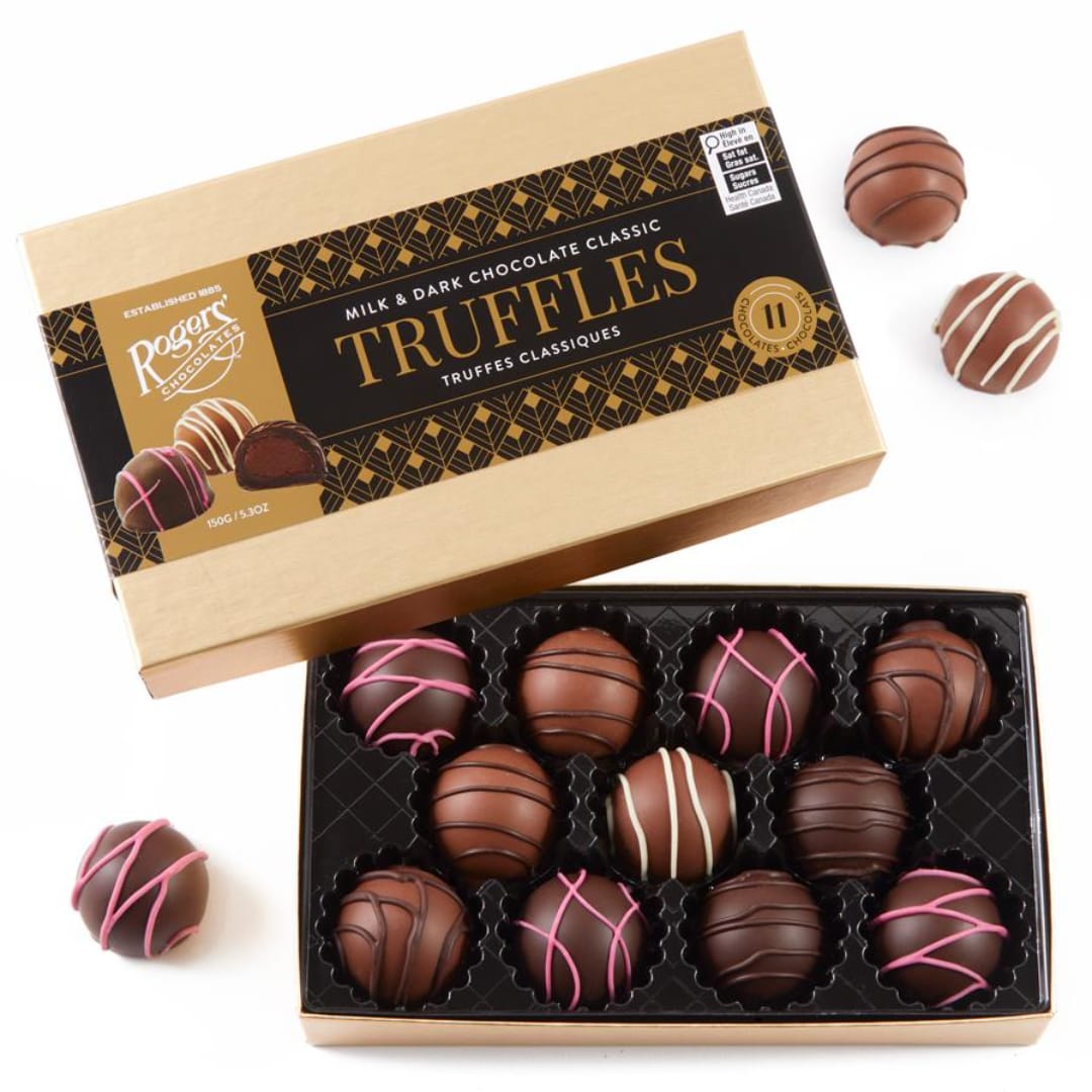 Box of assorted chocolate truffles with a few pieces outside the tray