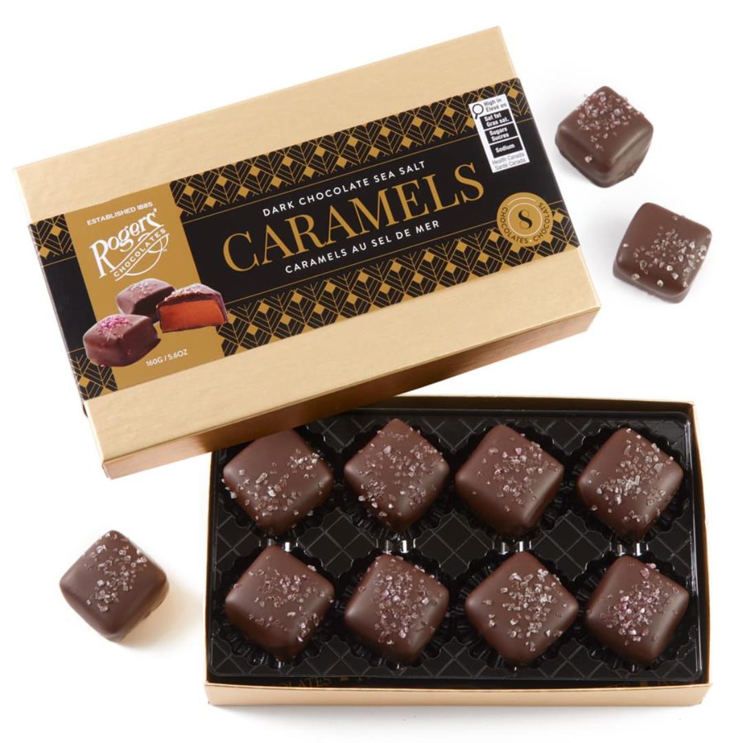 Box of dark chocolate sea salt caramels with pieces outside the box