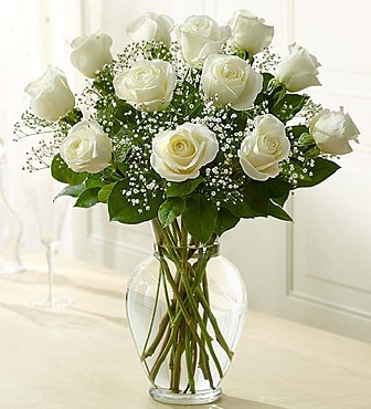 White roses arranged in a clear glass vase