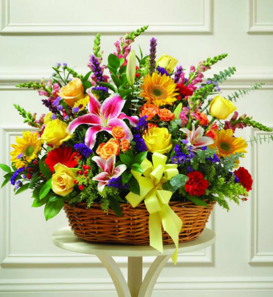 Colorful mixed flower basket with a yellow ribbon