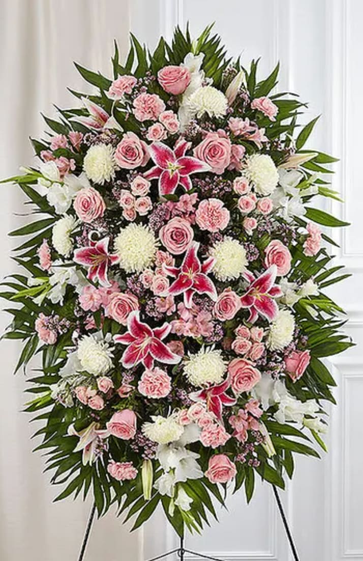Large standing floral spray with pink and white flowers on an easel
