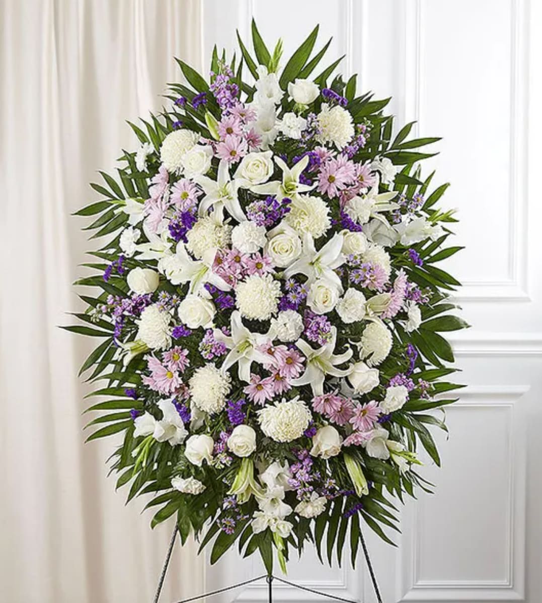 Large standing floral spray with white, pink, and purple flowers