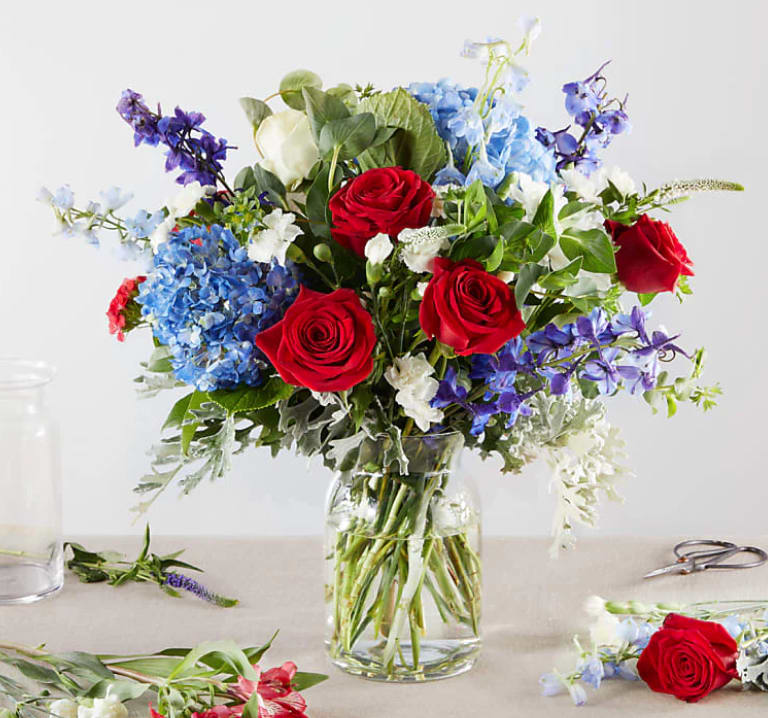 Star Spangled Blooms - Raise a flag of flowers for America's holidays. Our Florist Originals Bouquets are created by local florists using the finest quality flowers. The actual design you or your recipient will receive will be different from the images shown here.