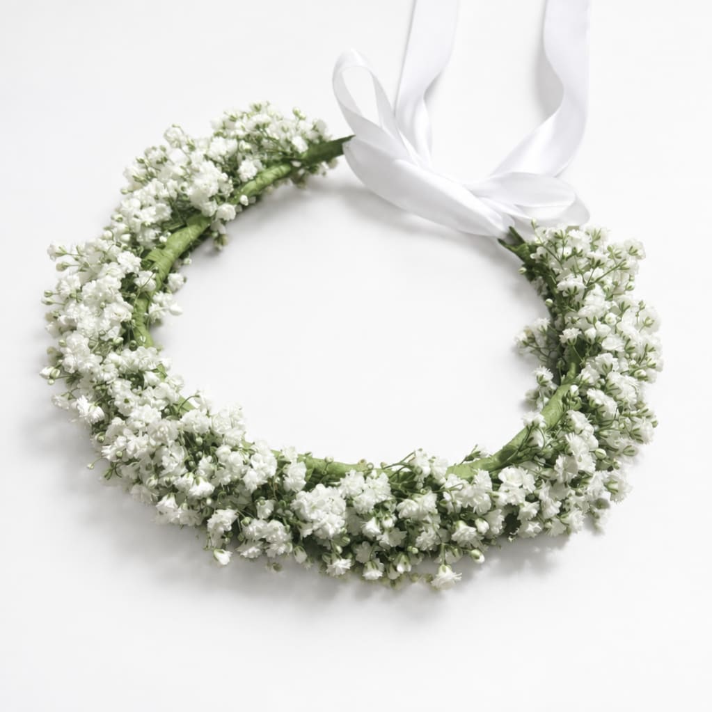 White floral wreath with a satin ribbon bow