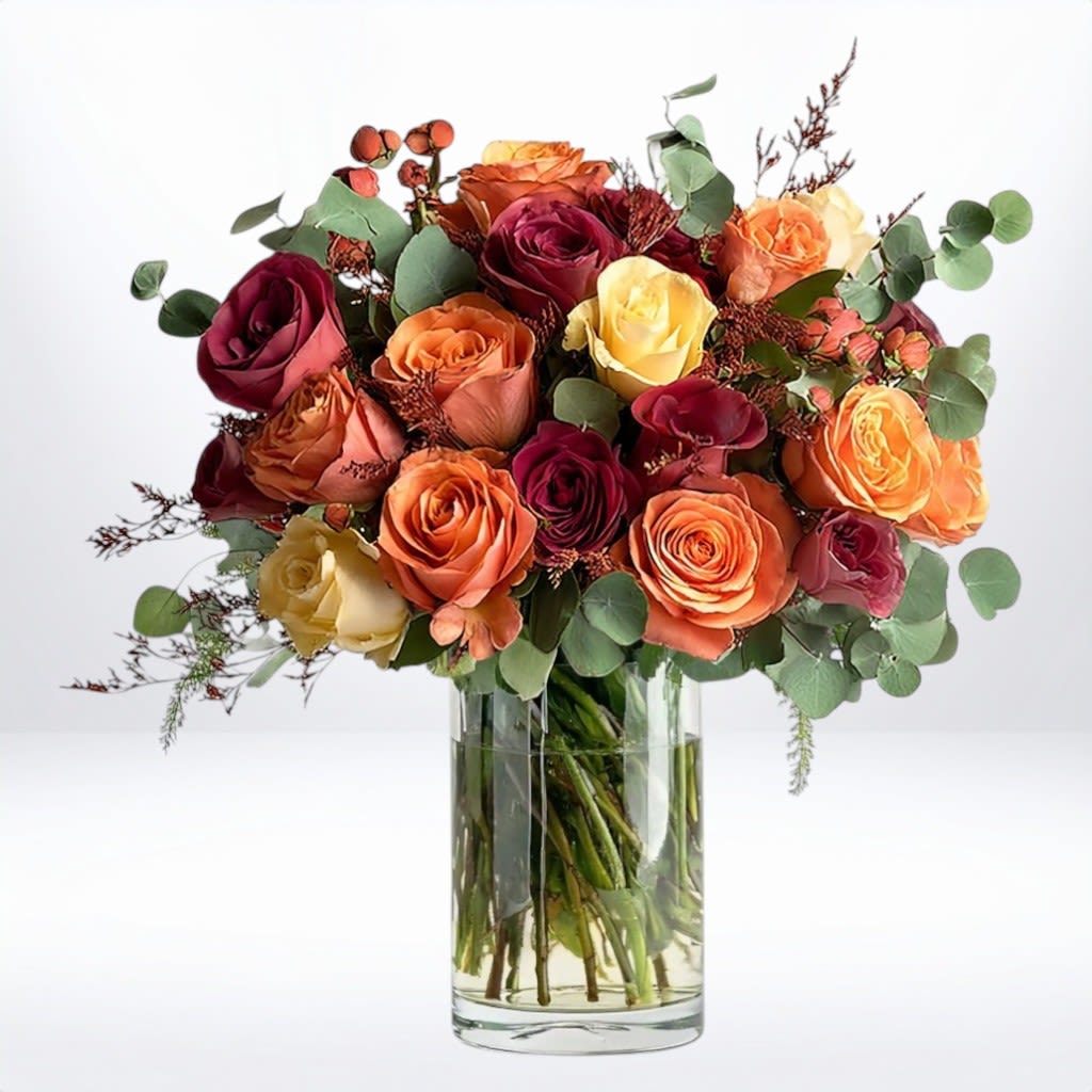 Bouquet of multicolored roses in a clear glass vase
