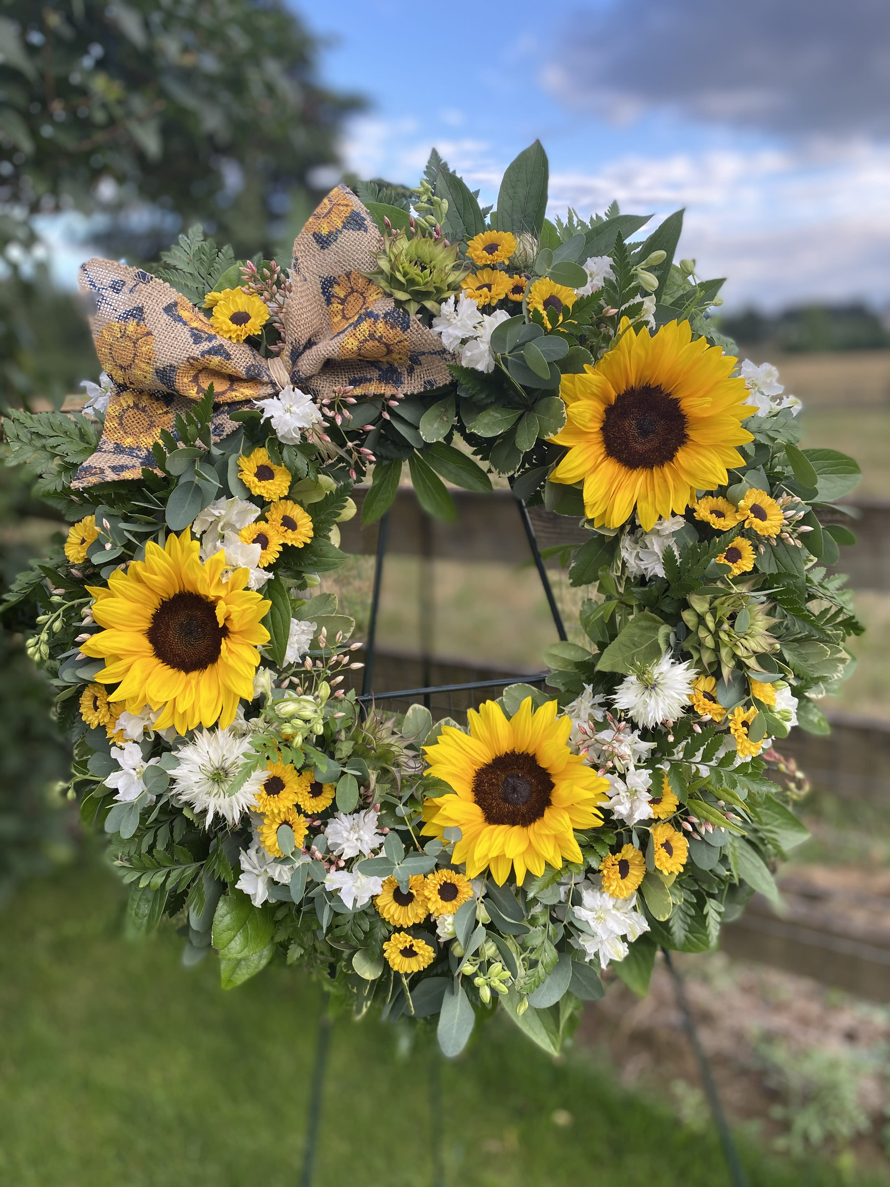 Sunflower wreath with white flowers and a burlap bow
