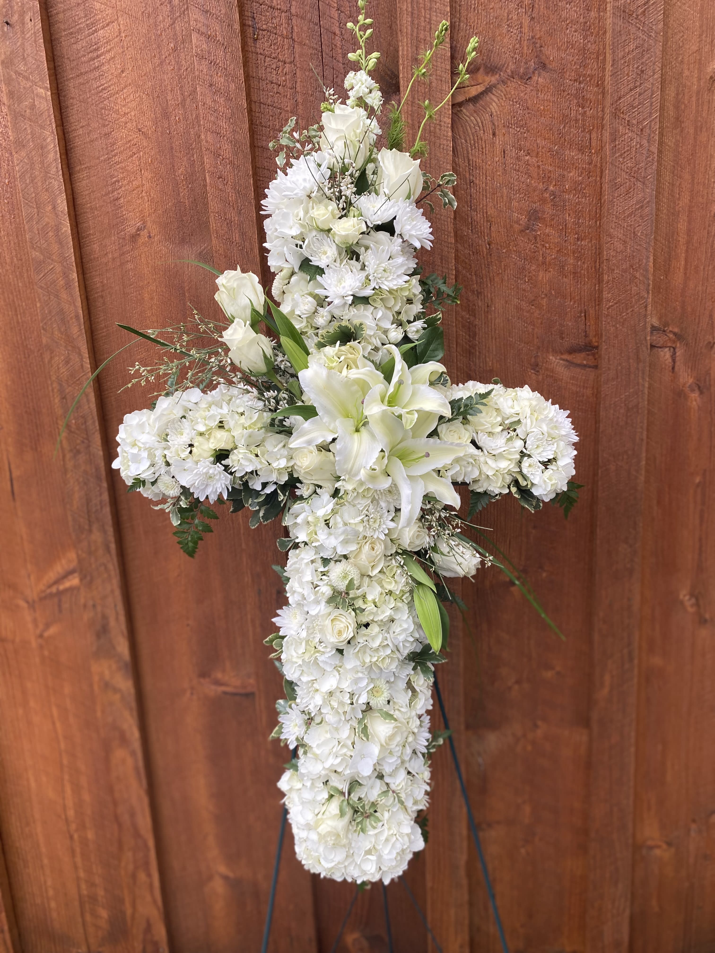 White floral cross arrangement with lilies and chrysanthemums