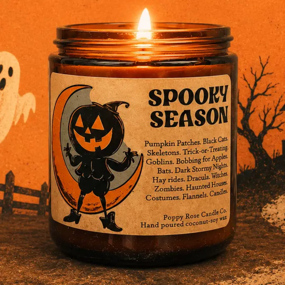 Lit Halloween candle in an amber glass jar with a spooky label