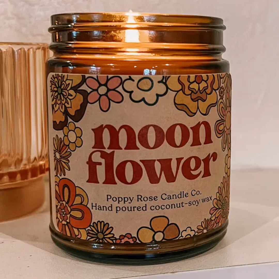 Amber glass candle jar labeled "moon flower" with floral graphics
