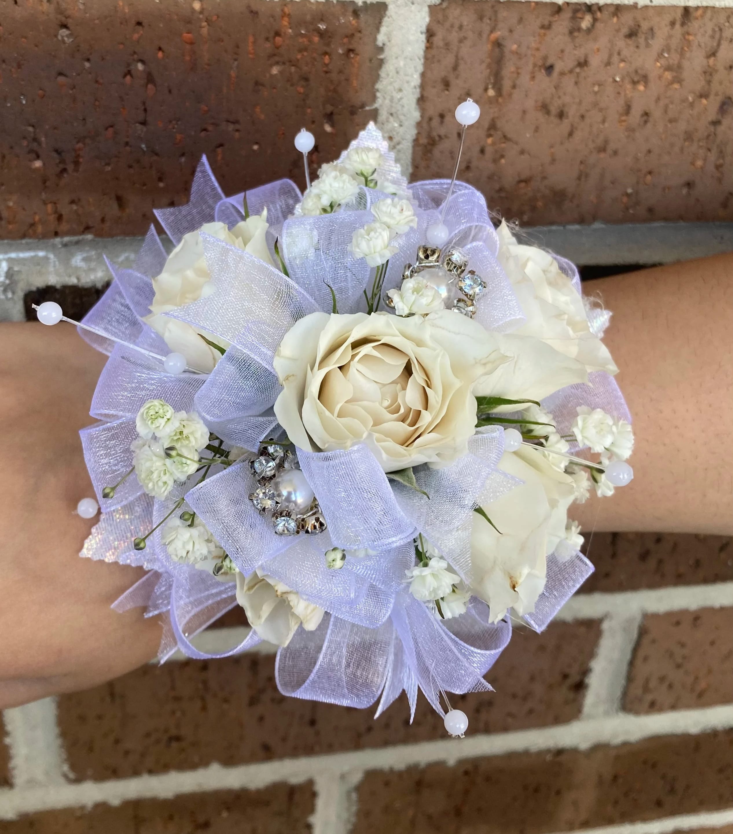 Small white rose bouquet with lavender ribbon and pearl picks