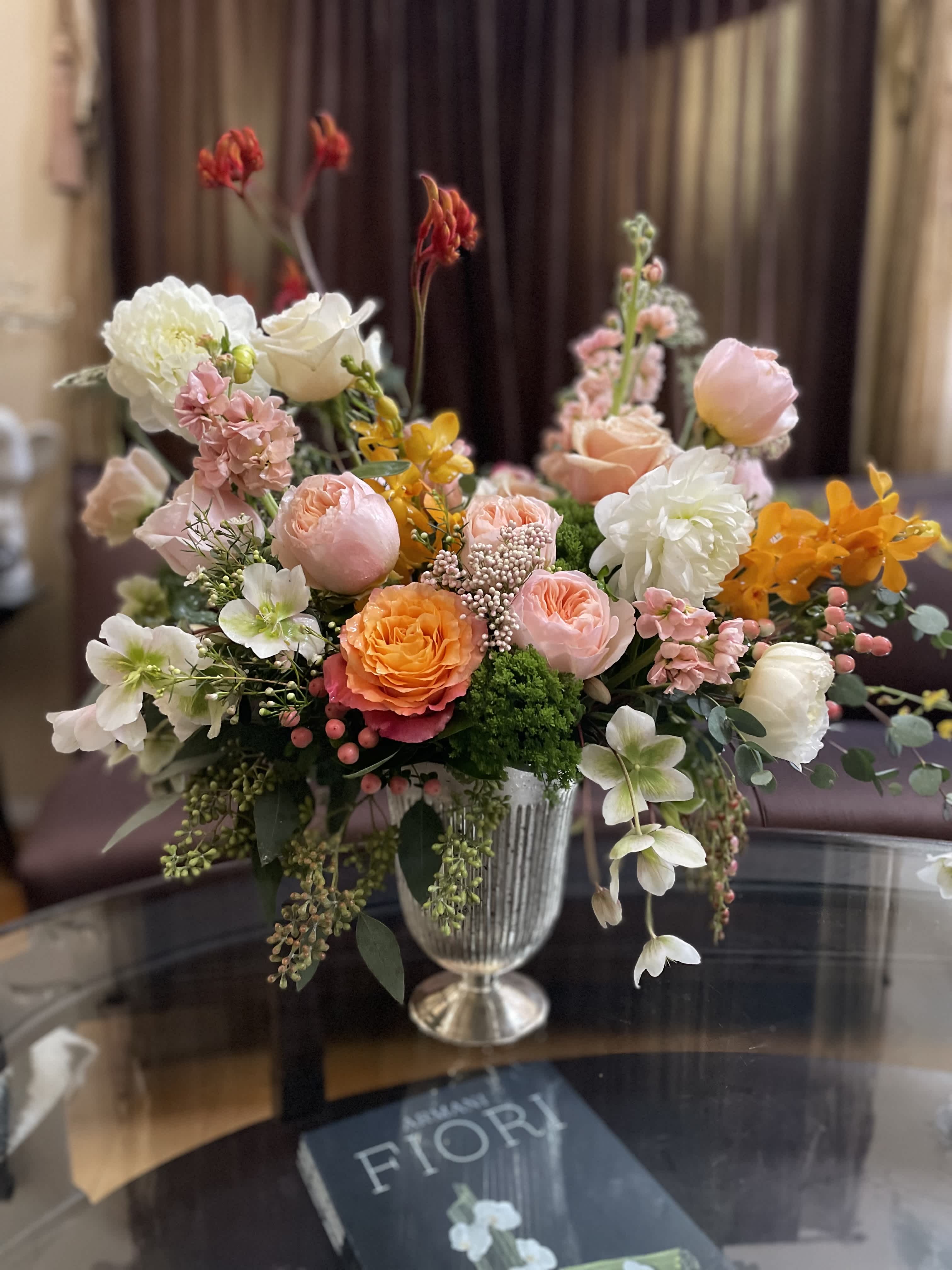 Mixed pastel flower arrangement in a silver vase