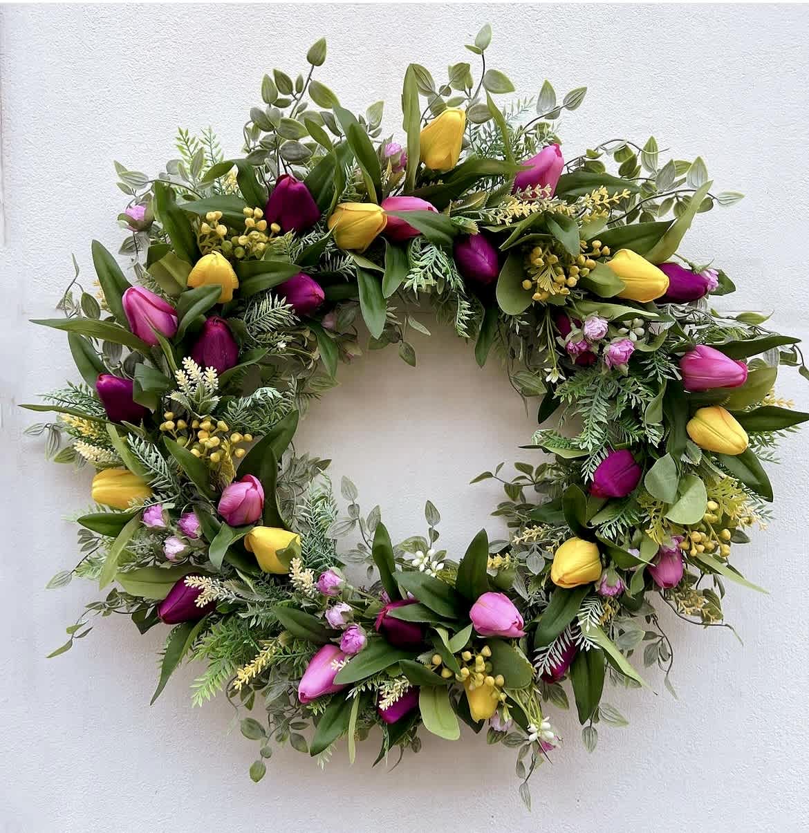 Circular wreath with pink and yellow tulips and mixed greenery