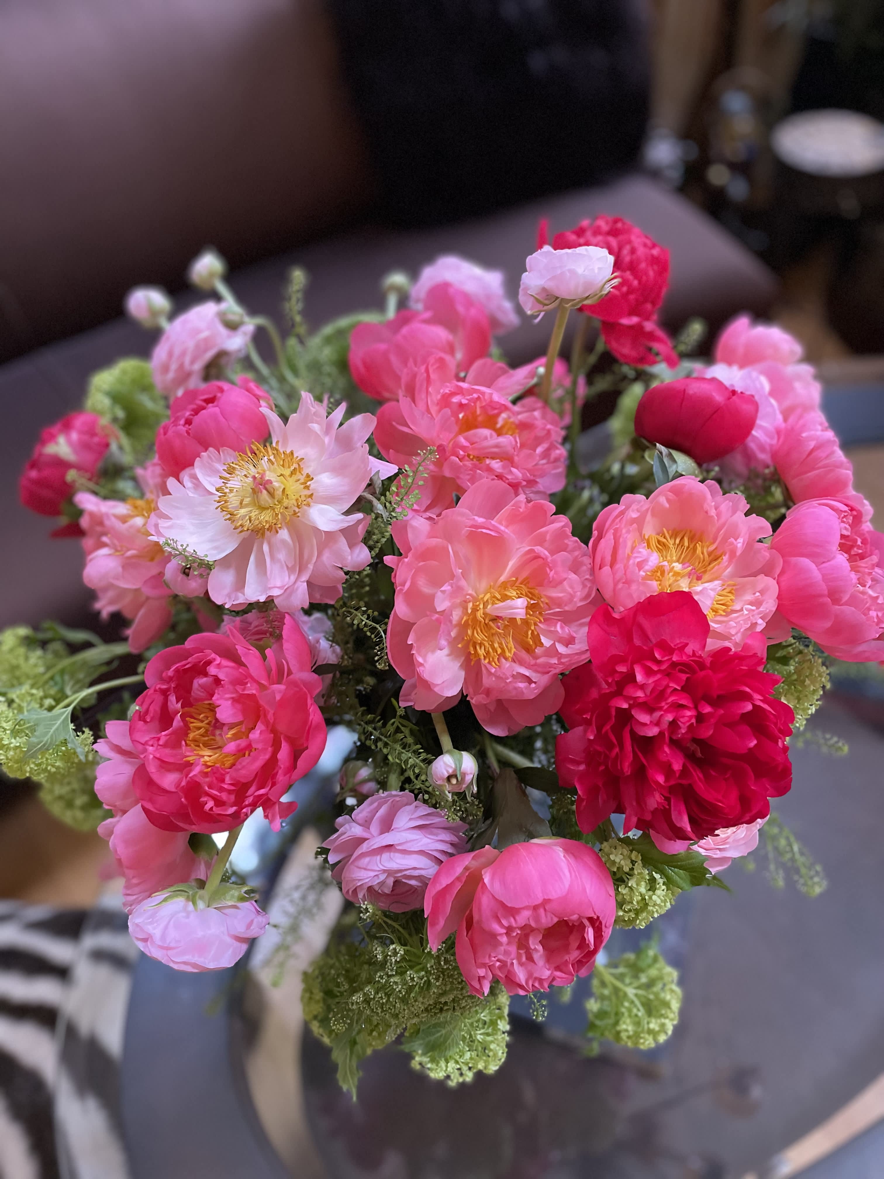 Bouquet of pink peonies and pale pink blooms with green filler