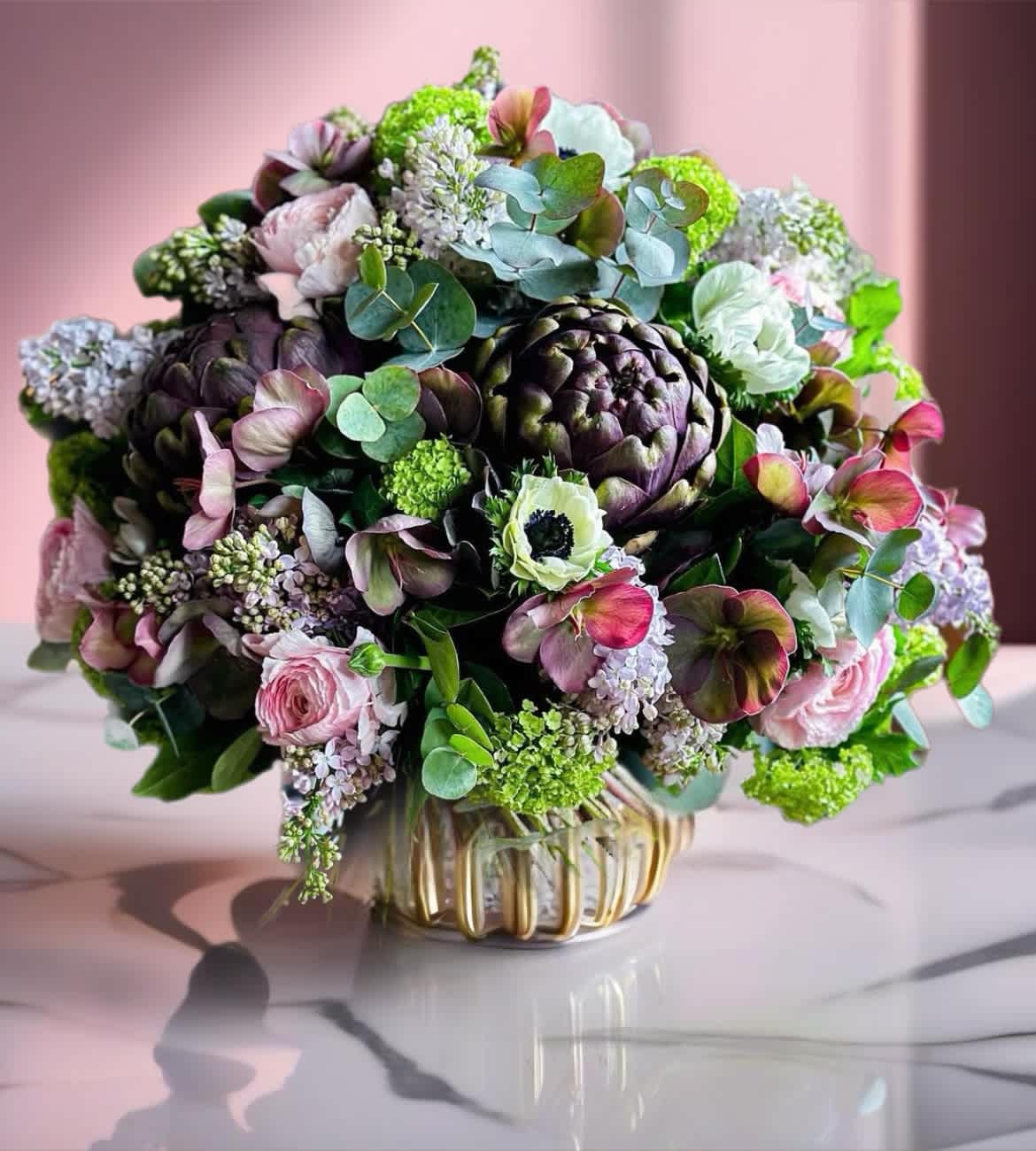 Bouquet of pink and green flowers in a glass vase
