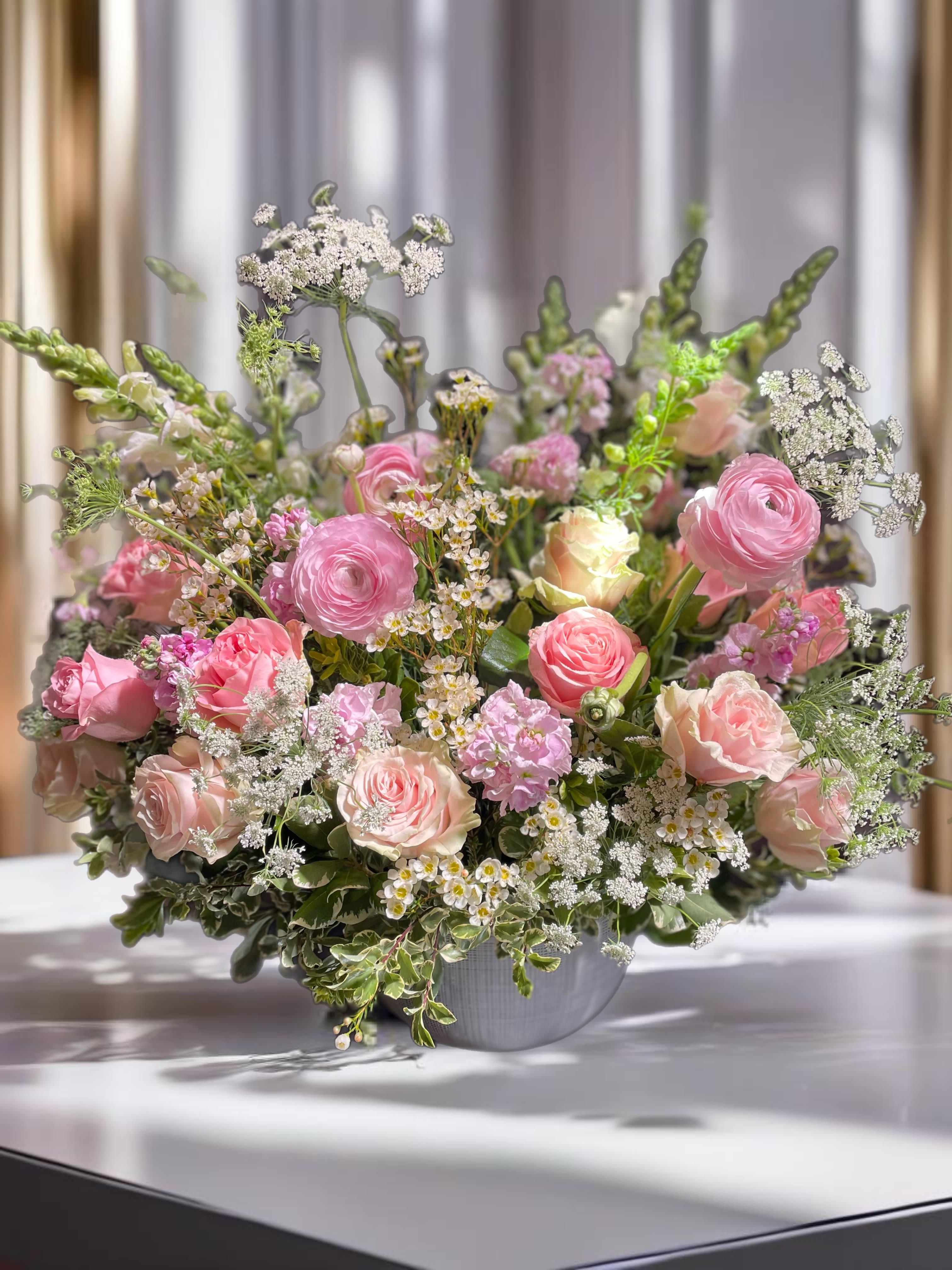 Pink and blush mixed flower arrangement in a gray vase