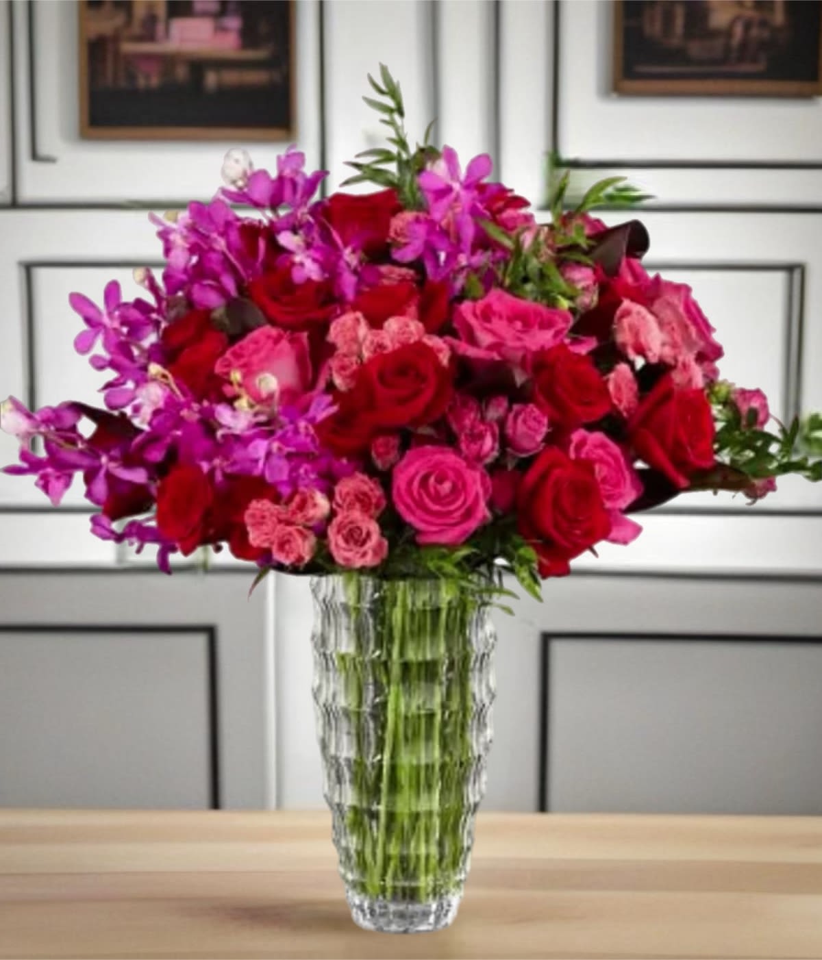Pink and red rose bouquet in a clear glass vase