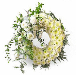 Heart-shaped floral wreath with white flowers and greenery