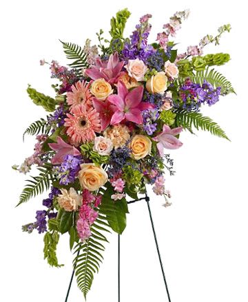 Standing floral spray with pink lilies, roses, and purple flowers