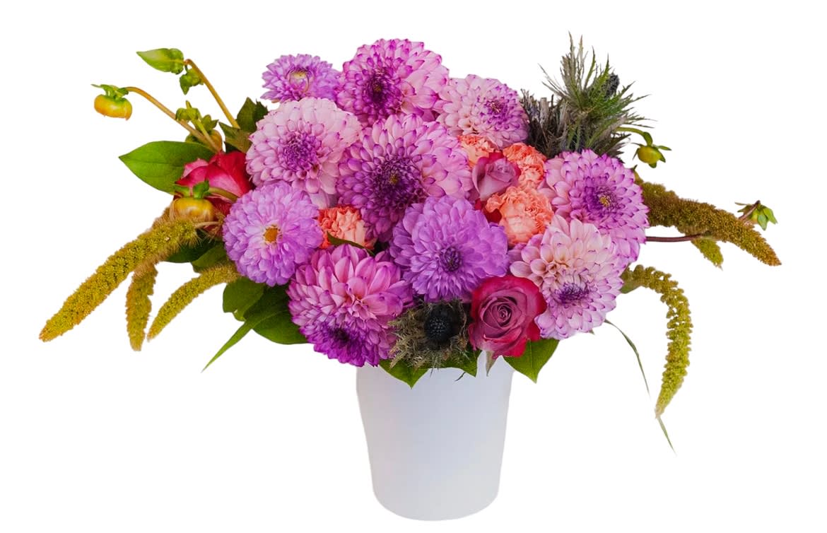 Pink and purple bouquet in a white vase with a few roses and textured blooms