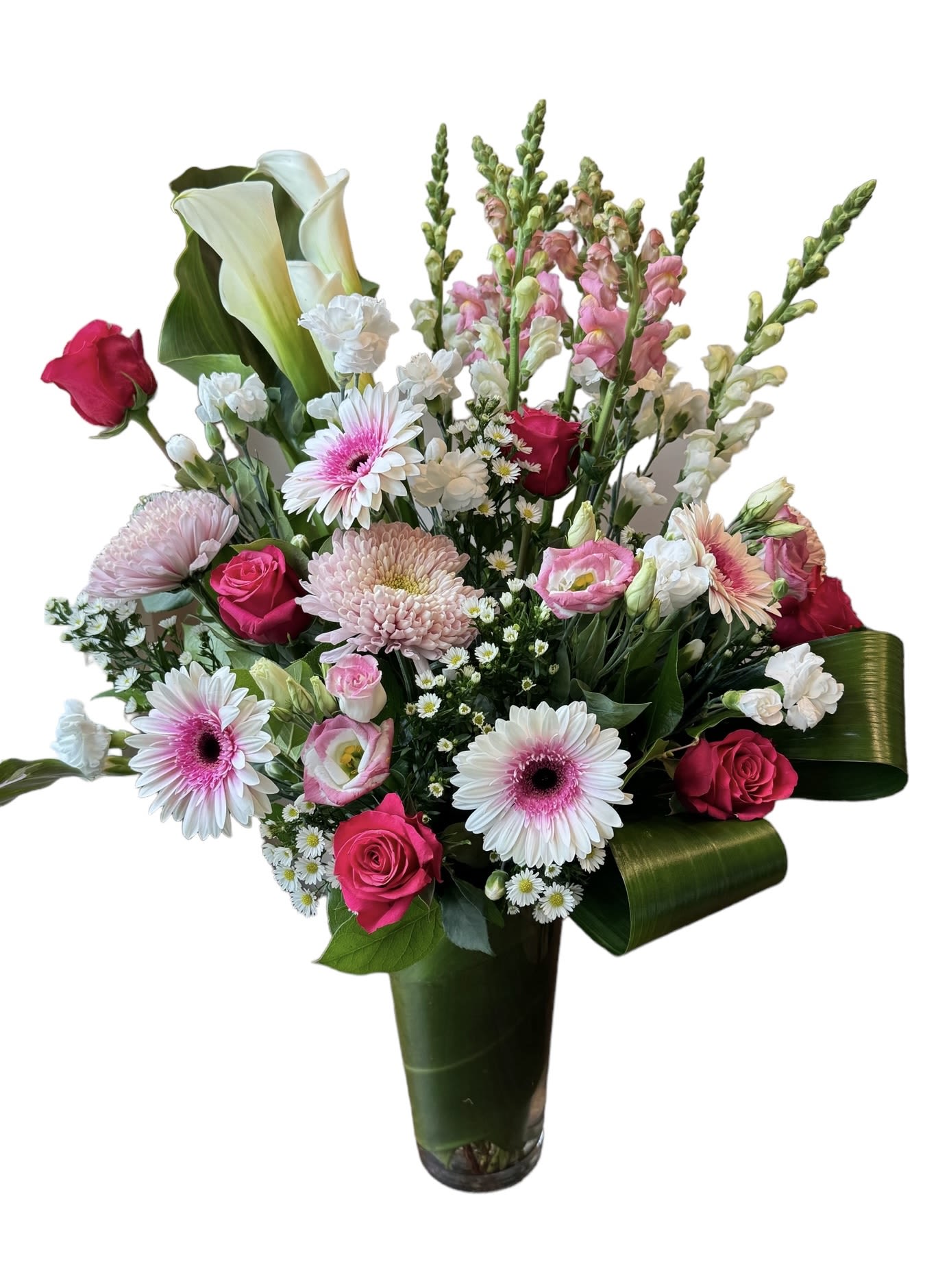 Mixed bouquet with pink roses, gerbera daisies, calla lilies, and snapdragons in a vase