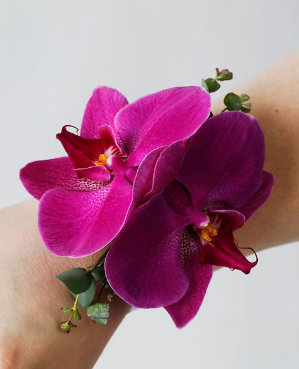 Purple orchid corsage on a wrist