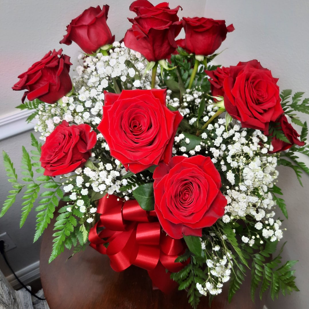 Bouquet of red roses with white baby's breath and a red ribbon