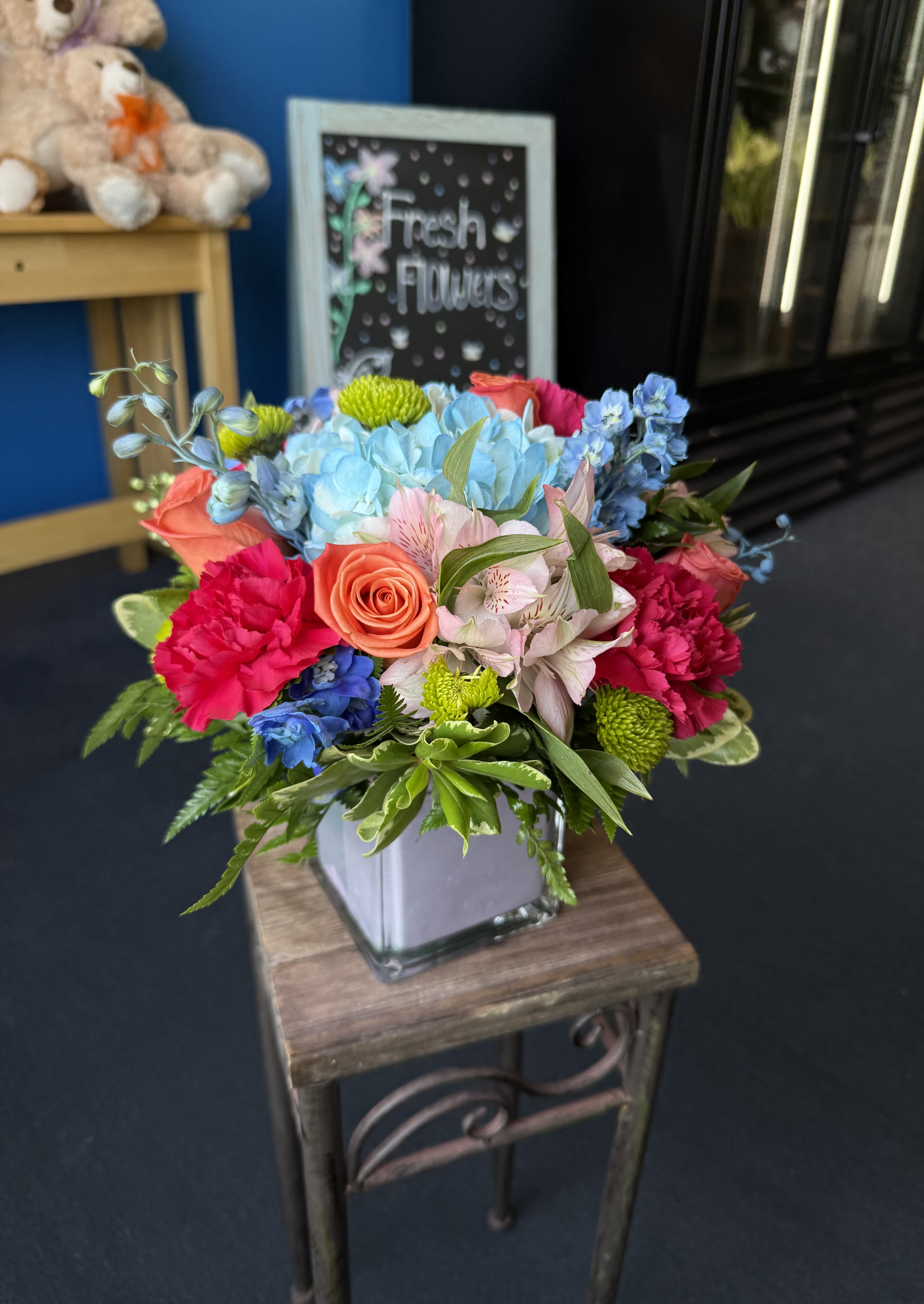 Colorful mixed bouquet in a square glass vase