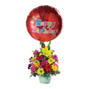 Birthday balloon above a colorful mixed flower arrangement in a vase