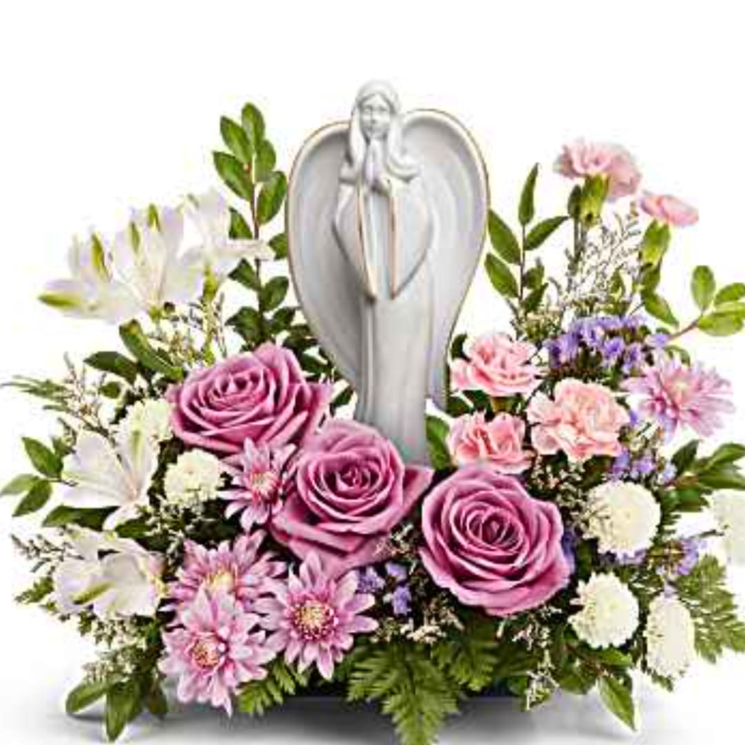 Pink roses and white flowers arranged around a silver angel figurine