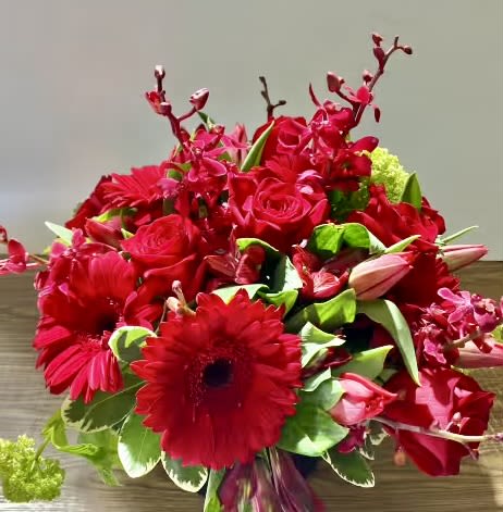 Red bouquet with roses, gerbera daisies, and orchids