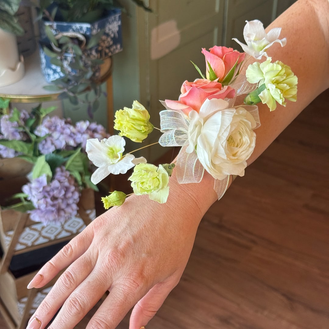 Floral wrist corsage with pink and white blooms on a sheer ribbon band