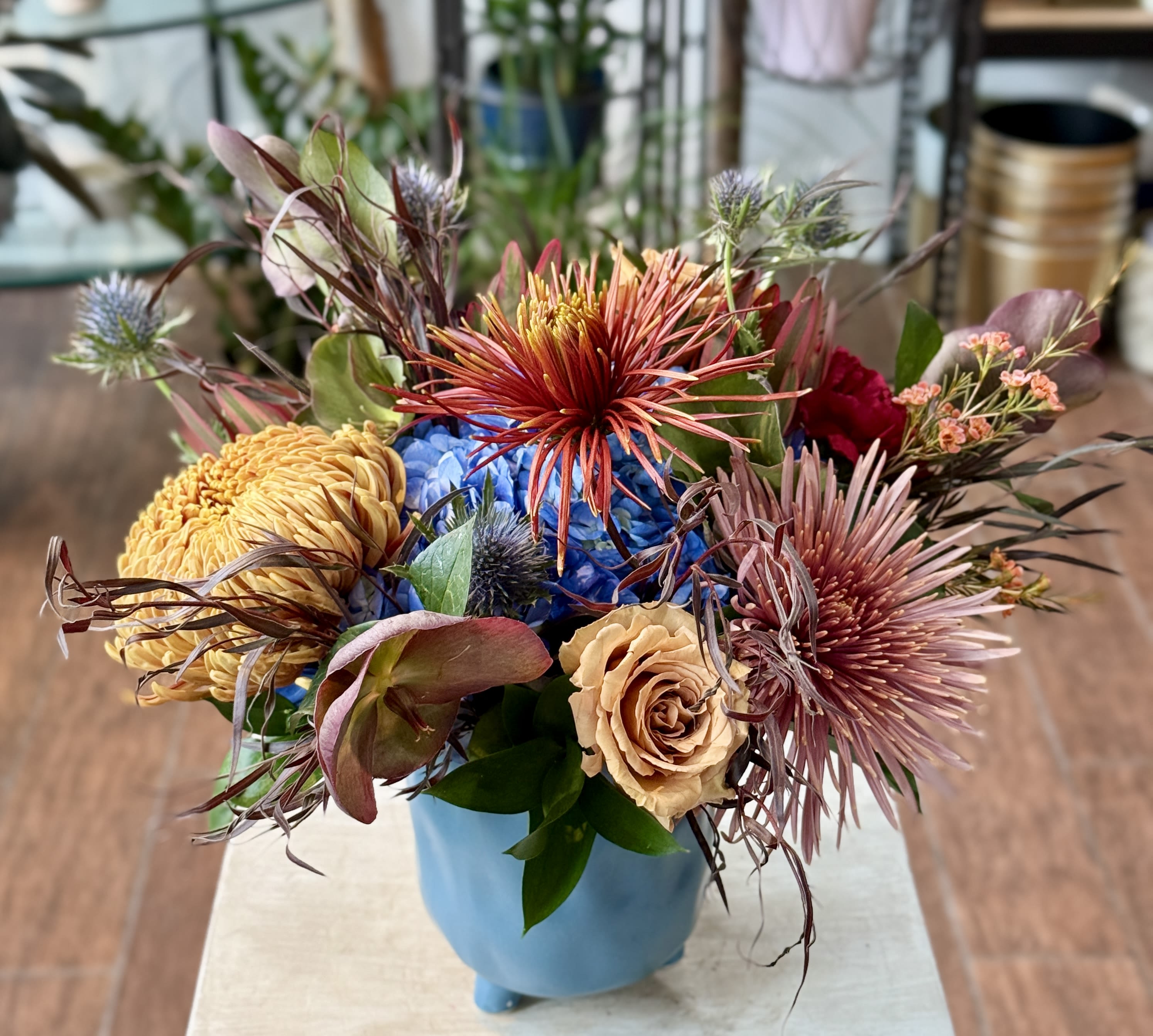 Owen - Autumn centerpiece in a blue ceramic container.