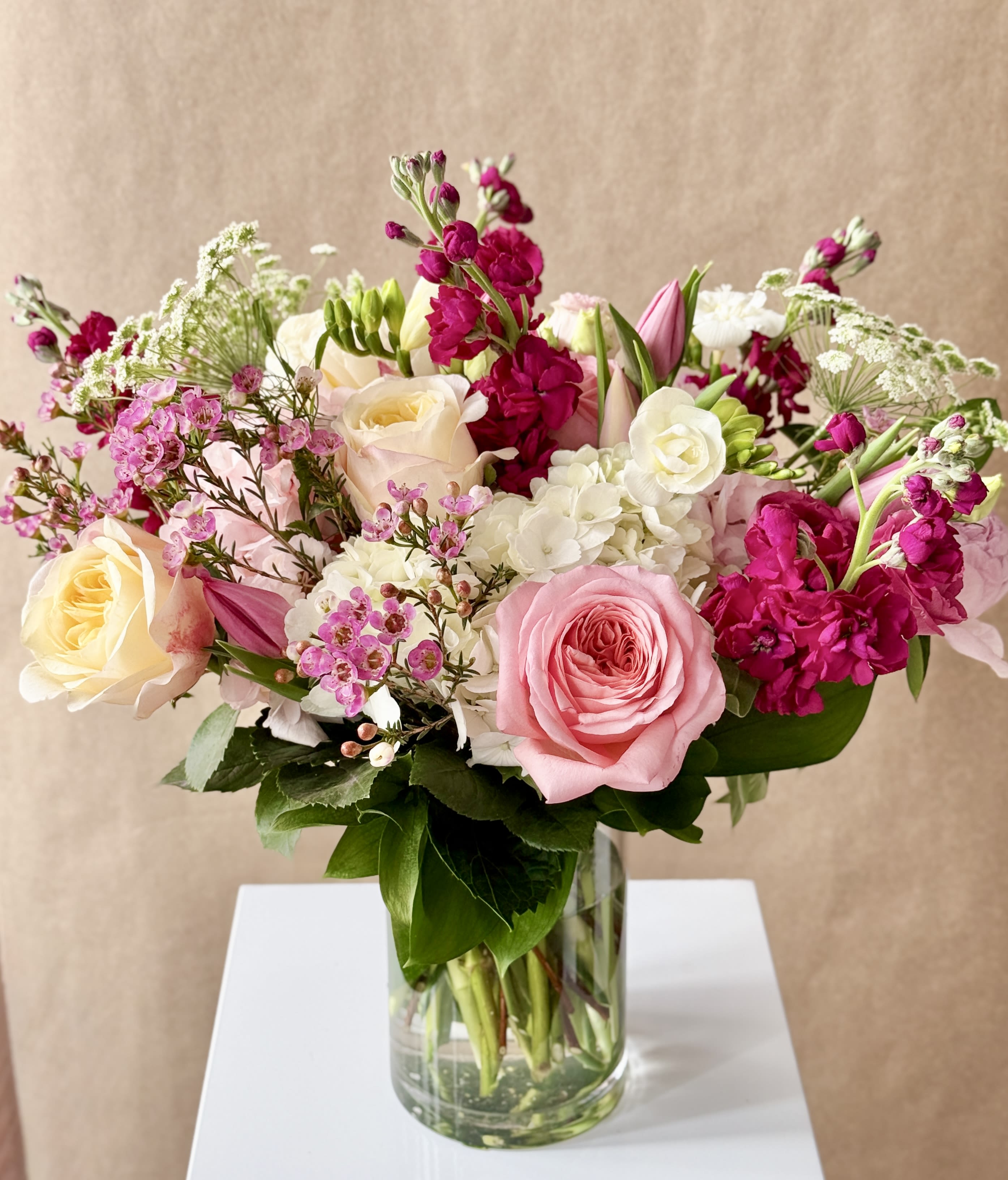 Pink and white mixed flower bouquet in a clear glass vase